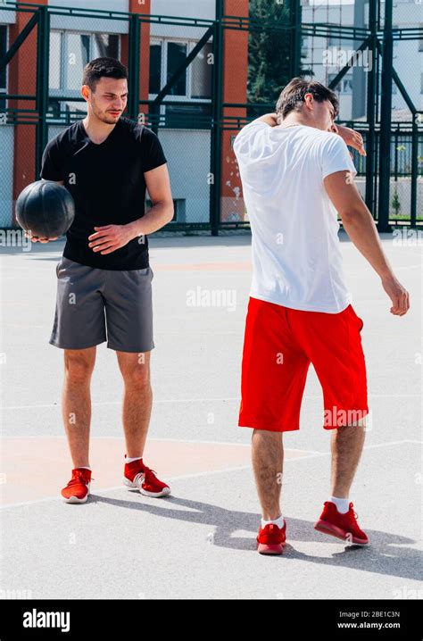 Two strong basketball player playing ball on an urban city basketball ...