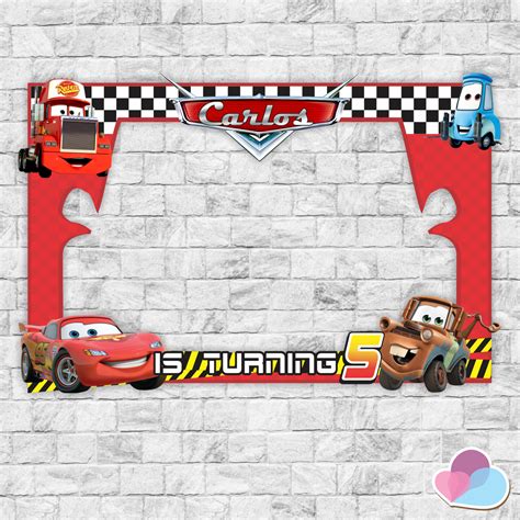 the cars photo frame is hanging on a brick wall with an image of lightning and mater