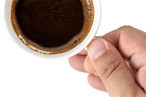 Top View of Cup of Black Coffee in the hand above white background (Flip 2019) - Creative ...