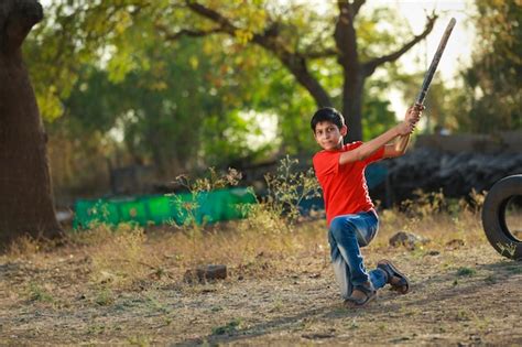 Premium Photo | Rural indian child playing cricket