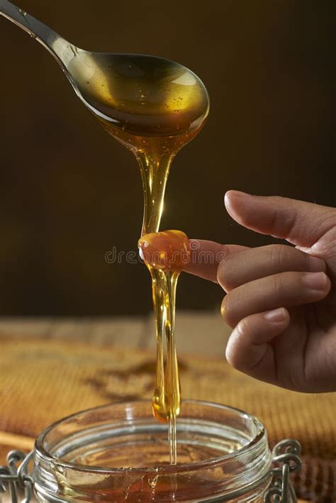 Honey Dripping from a Spoon Stock Image - Image of wooden, health: 33771687