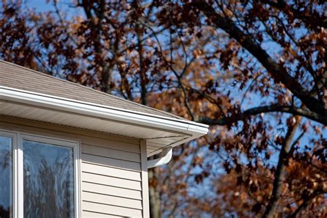 Back corner view of the colonial with siding and the LeafGuard gutters ...