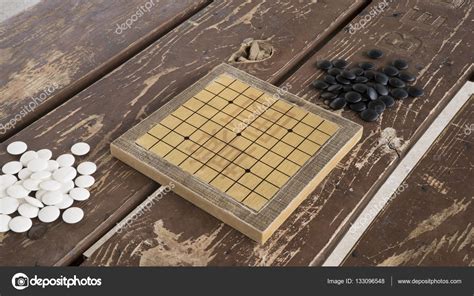 Chinese Go or Weiqi board game. Black and white stones and hand made ...