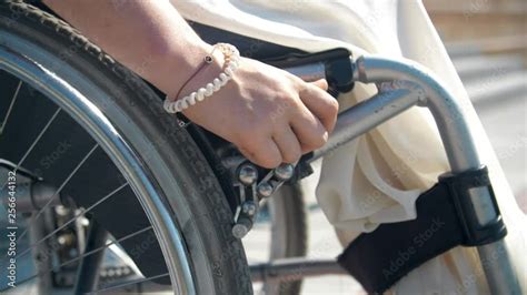 Hand Brake system of wheelchair for safety. Woman blocking wheel of the ...