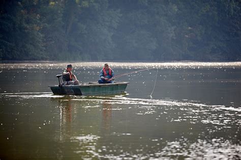 Two Senior Men Fishing From A Small Boat On Lake Stock Photo - Download ...