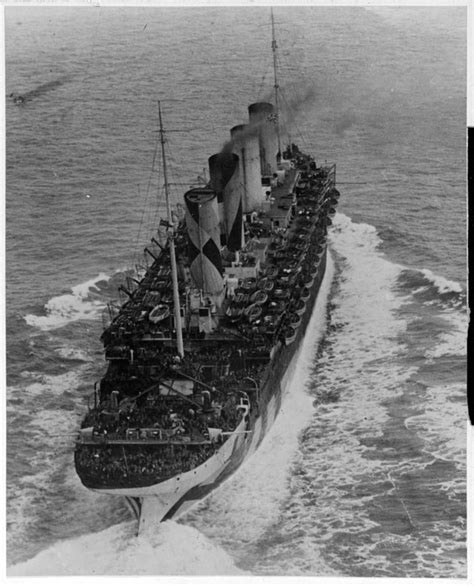 RMS Queen Mary underway at sea at high speed while serving as a troopship, 8 December 1942 ...