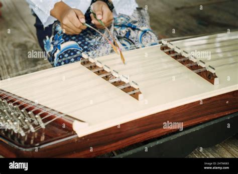 Thai girl playing Khim, the traditional Thai music Instrument. Leisure and hobby Stock Photo - Alamy