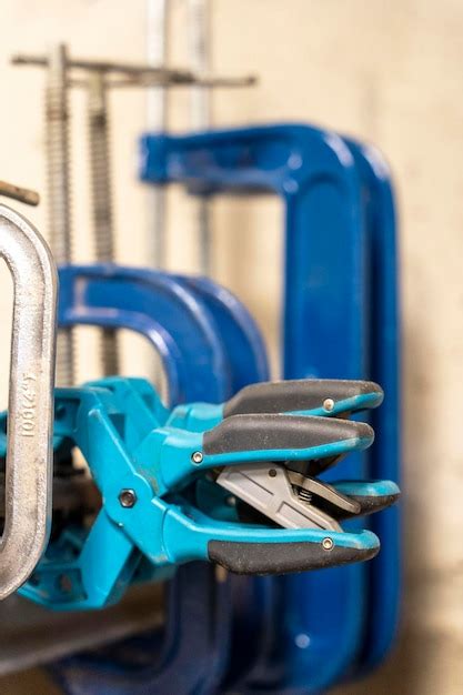 Premium Photo | Hand clamps on the welding table in the auto repair shop