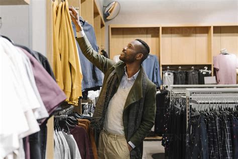 Stylish man shopping in a clothes store stock photo