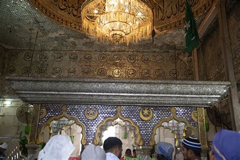 Woman at the steps leading to the sea with Haji Ali Dargah in the ...