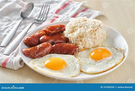 Filipino Silog Breakfast with Garlic Fried Rice, Longsilog, and Two Sunny Side Up Eggs Stock ...