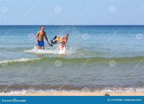 Young People Splashing in the Sea, a Young Man Splashing Water on a Girl Editorial Stock Image ...