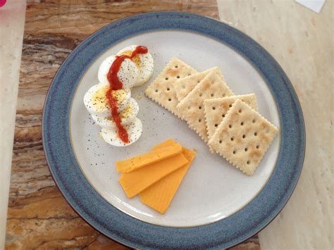 5 saltines, 1 ounce of cheddar cheese and a hard boiled egg drizzled ...