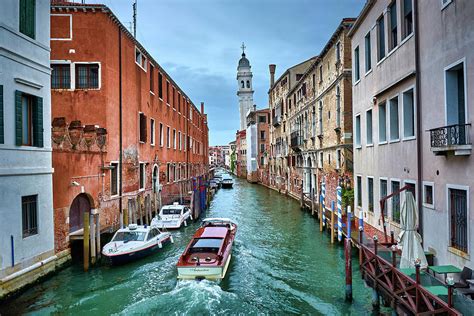 Boat Navigating On Venetian Canals In Venice, Italy Photograph by Eduardo Accorinti