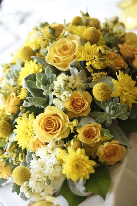 Yellow centerpieces with roses, billy balls, succulents, and other filler flowers. Love ...