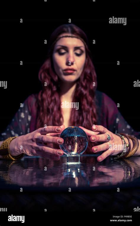 Fortune teller forecasting future with crystal ball Stock Photo - Alamy