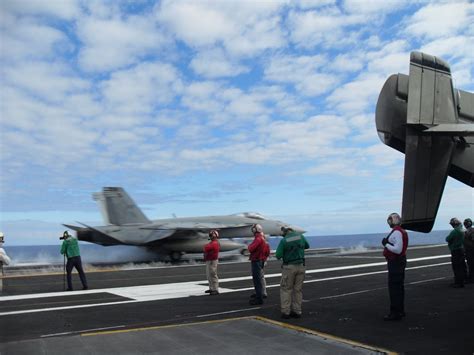 Watching the launch on the flight deck of an aircraft carrier ...