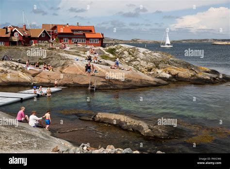 Sunbathers on rocky coastline, Käringön island, Bohuslän Coast, Southwest Sweden, Sweden ...