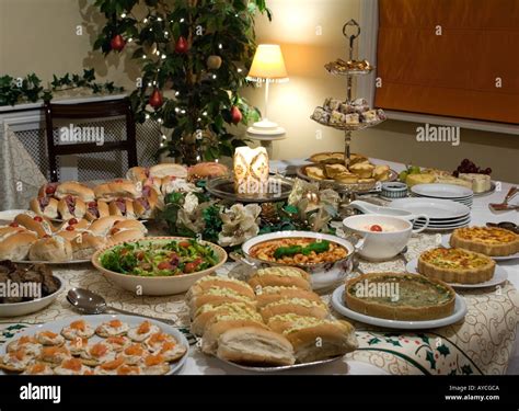 Christmas party table set with candle and luxury food Stock Photo - Alamy