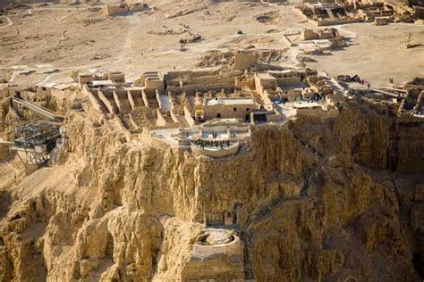 Today, the vast ruined fortress of Masada set on a flat mountain top, high above the rugged ...