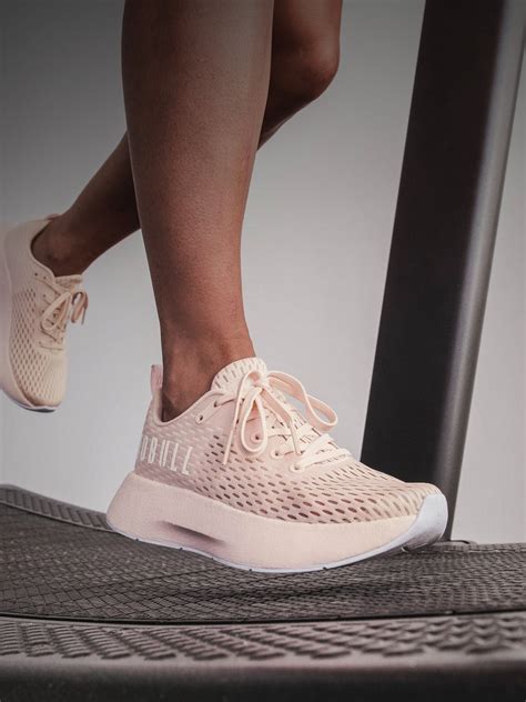 female athlete wearing blush white runner+ on a treadmill