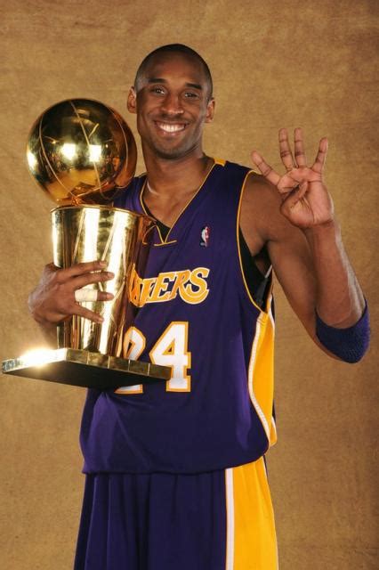 Kobe Bryant holds the Larry O'Brien trophy and 4 fingers.jpg (2 comments)