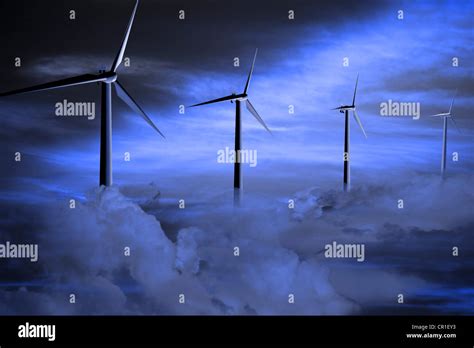 Wind turbines among clouds Stock Photo - Alamy