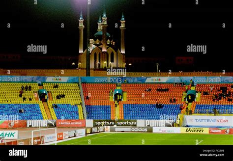 Old Rubin Kazan football stadium overlooked by the Qol Sherif mosque located in the Kremlin, lit ...