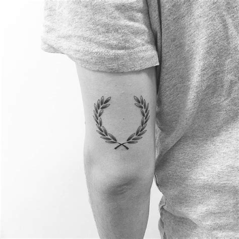 Laurel wreath tattoo on arm - Tattoogrid.net