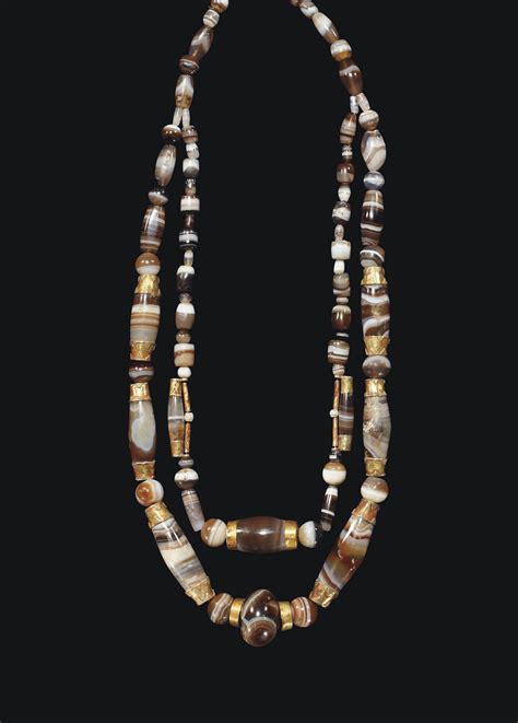 A WESTERN ASIATIC BANDED AGATE AND GOLD BEAD NECKLACE , ASSYRIAN TO PARTHIAN PERIOD, CIRCA 800 ...