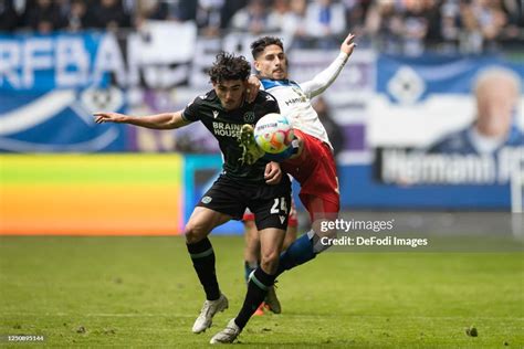 Antonio Foti of Hannover 96 and Ludovit Reis of Hamburger SV battle ...