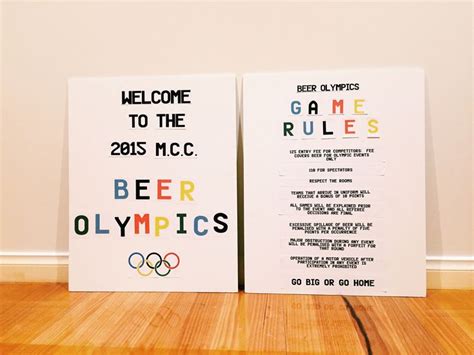 two posters with the olympic games and beer olympics written on them are sitting on a wooden floor