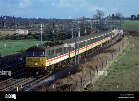 Class 86 electric locomotive number 86256 with a matching rake of InterCity coaches heads north ...