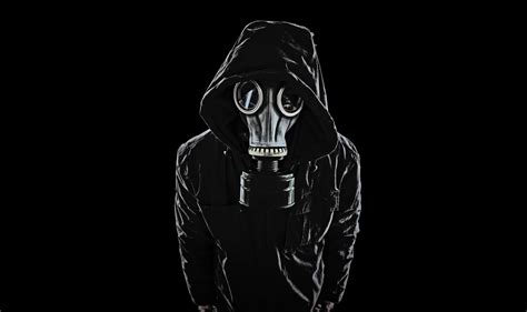 a man wearing a gas mask and black hoodie