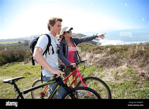 Couple on biking day looking at scenery Stock Photo - Alamy