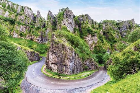 an aerial view of a winding road in the mountains