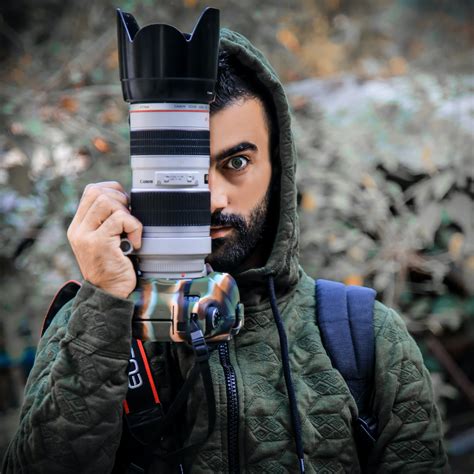 Person Holding a Dslr Camera · Free Stock Photo