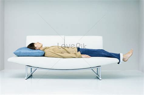 Man Lying On Modern Sofa Picture And HD Photos | Free Download On Lovepik