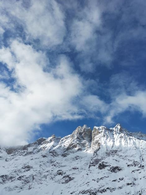 Premium Photo | A mountain top with snow on it and the sky is blue.