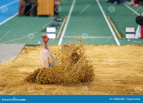 Long Jump Sportsman Landing into Sand Pit Stock Photo - Image of jump ...