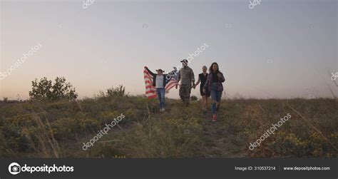 Soldier and his family walking on a meadow Stock Photo by ...