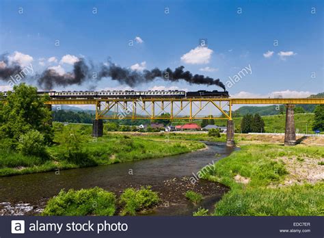 Steam train on railway bridge Stock Photo, Royalty Free Image: 77101327 - Alamy