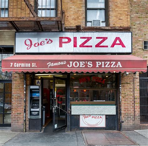 the entrance to joe's pizza restaurant in an old brick building with red awnings