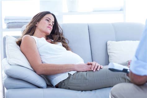 Sad pregnant woman relaxing on sofa at home | Prospan Arabia