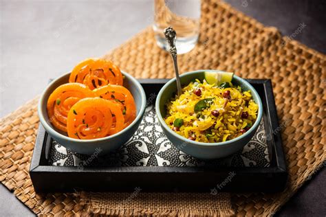 Premium Photo | Aloo Poha with Jalebi snack combination also called ...