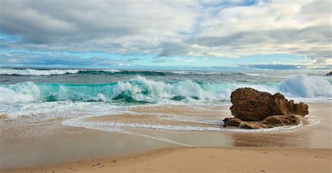 Foamy waves of powerful sea rolling on sandy beach · Free Stock Photo