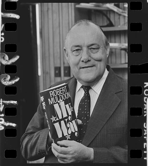 Prime Minister Robert Muldoon holding up a copy of his third ...