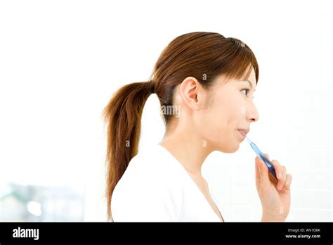 Japanese woman brushing teeth Stock Photo - Alamy