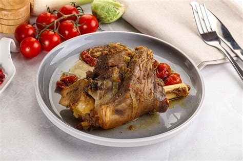 Premium Photo | Baked lamb shank with bone marinated in spices