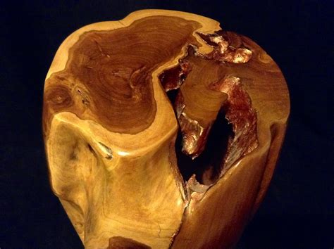 a wooden bowl that has been carved to look like an animal's head